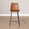 A brown leather bar stool with black metal legs is shown against a light gray wall and a wooden floor. Produktbild-Vorschau