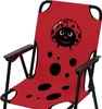 A close-up view of a red children's camping chair with a ladybug design. Produktbild-Vorschau