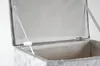 A close-up view of the inside of an open laundry basket, showing the hinges and lining. Podgląd zdjęcia produktu