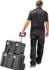 A person is pulling a stack of two black toolboxes on wheels. Anteprima dell’immagine prodotto