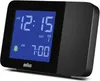 A black Braun digital alarm clock with a blue display is shown against a white background. Anteprima dell’immagine prodotto