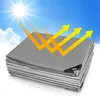 A stack of gray tarps under a sunny sky with arrows indicating reflection. Produktbild-Vorschau