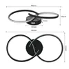 Diagrams showing the dimensions of a modern black ceiling light with two interlocking rings. Voir les images du produit