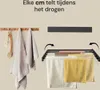 A split image showing two different ways to hang towels. On the left, two towels are hung on hooks. On the right, a black wall-mounted drying rack is shown with several towels hanging on it, and arrows indicating it can be folded. Náhľad obrázku produktu