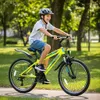 A young boy is riding a bicycle in a park. Produktbild-Vorschau