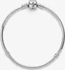 A silver Pandora bracelet with a single charm is displayed against a white background. Podgląd zdjęcia produktu
