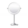 A silver LED makeup mirror with a round base and a single stem, set against a white background. Produktbild-Vorschau