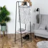 A clothing rack with clothes and accessories in a room with a chair and plant. Produktbild-Vorschau