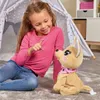 A young girl is playing with a stuffed dog inside a tent. Anteprima dell’immagine prodotto