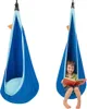 A child reading in a blue hanging pod chair. Náhled obrázku produktu