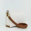 A white handbag with brown accents and strap is shown against a white background. Náhľad obrázku produktu