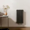 A modern bathroom or living space with a radiator mounted on the wall next to a small side table with decorative items. Produktbild-Vorschau