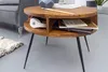 A round wooden coffee table with black metal legs, featuring a storage compartment with books and headphones. Voir les images du produit
