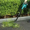 A person is using a leaf blower to clear debris from a sidewalk next to a hedge. Produktbild-Vorschau