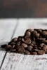A pile of chocolate drops on a wooden surface. Produktbild-Vorschau