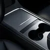 A close-up view of a car's center console, showing a black accessory with cup holders. Voir les images du produit