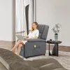 A woman sitting in a gray recliner chair with a laptop. Anteprima dell’immagine prodotto