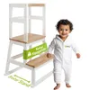 A child stands next to a wooden learning tower. Produktbild-Vorschau