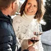 A couple enjoying wine outdoors in a snowy environment. Produktbild-Vorschau