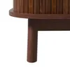 A close-up view of the lower section of a wooden cabinet, showing one of its legs and the underside of the top. Voir les images du produit
