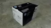 A black and white HP toner cartridge box sits on a concrete floor. Náhľad obrázku produktu