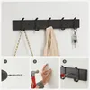 A wall-mounted coat rack with hooks, showing installation steps below. Produktbild-Vorschau