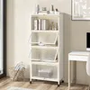 A white shelving unit with clear doors is shown in a room with a desk and a window. Produktbild-Vorschau