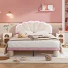 A children's bedroom with a pink and beige bed, adorned with a seashell-shaped headboard and soft lighting. Náhled obrázku produktu
