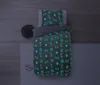 A top-down view of a child's bed with bedding featuring a glow-in-the-dark sports ball pattern. Produktbild-Vorschau