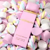 A pink perfume bottle surrounded by colorful marshmallows. Náhľad obrázku produktu