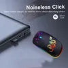 A wireless mouse with colorful RGB lighting is placed next to a laptop. Produktbild-Vorschau