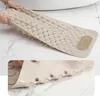 A beige bath mat is shown from two angles, one showing its textured surface and the other its suction cups. Produktbild-Vorschau
