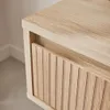 A close-up view of a wooden nightstand with a slatted drawer front. Produktbild-Vorschau