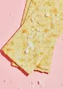 A close-up shot of salt-sprinkled crackers on a pink background. Produktbild-Vorschau