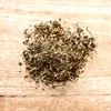 A pile of dried animal feed on a wooden surface. Produktbild-Vorschau