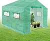 A green greenhouse with plants inside, set on a grassy lawn. Voir les images du produit