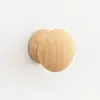Two wooden knobs are mounted on a white wall. Podgląd zdjęcia produktu