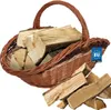 A wicker basket filled with firewood, with some firewood pieces scattered in front of it. Náhľad obrázku produktu