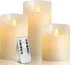Three LED candles of varying heights are displayed against a white background, with a remote control in the foreground. Podgląd zdjęcia produktu