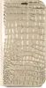 A close-up, top-down view of a gold, crocodile-textured phone case. Produktbild-Vorschau