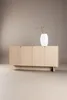 A light wood sideboard with four doors and a white vase with a dried branch on top, set against a neutral background. Produktbild-Vorschau