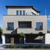 A modern concrete house with a garage and a mailbox. Produktbild-Vorschau