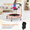 A young girl is jumping on a pink trampoline with LED lights in a living room. Produktbild-Vorschau