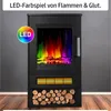 A black electric fireplace with a colorful LED flame effect and a stack of logs at the bottom, set against a gray wall and wooden floor. Produktbild-Vorschau