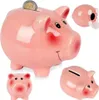 A collage of pink ceramic piggy banks, one with a coin inserted. Náhľad obrázku produktu