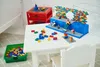 A table with LEGO creations and loose bricks. Voir les images du produit