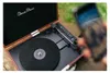 A close-up shot of a record player with a phone in the foreground. Produktbild-Vorschau