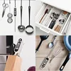 A collage of kitchen utensils and appliances, including a digital thermometer, ladles, a strainer, cutlery in a drawer, a spatula, a whisk, and a frying pan. Produktbild-Vorschau
