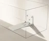 A white shelf bracket attached to a transparent box-like structure. Produktbild-Vorschau