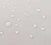 Close-up of water droplets on a light-colored fabric surface. Voir les images du produit